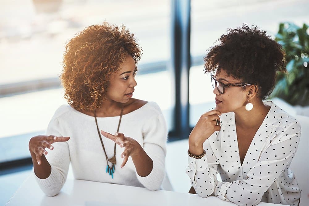 A Temah clinician in conversation with a patient